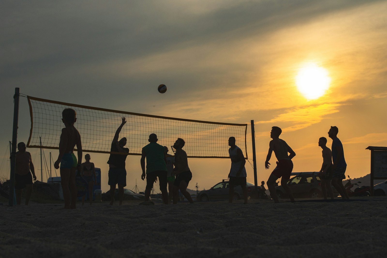 People playing recreational volleyball at sunset, an illustrative image rather than participants in the Volleyball England pilot